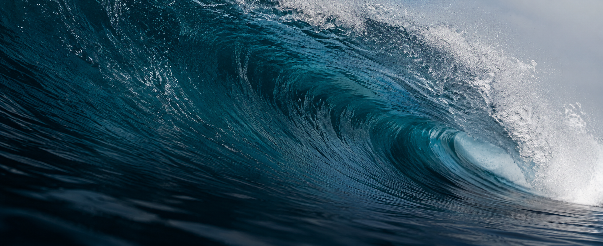 Blue barrel wave rolling toward shore